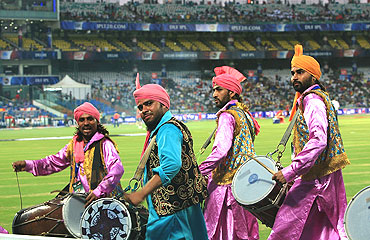 Men play the dhol during the match between Delhi Daredevils and Royal Challengers Bangalore