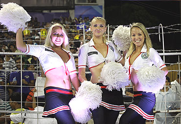Cheerleaders pose for pictures after their dance routine