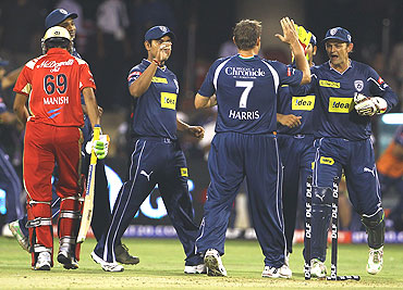Deccan Chargers players congratulate bowler Ryan Harris after dismissing Manish Pandey