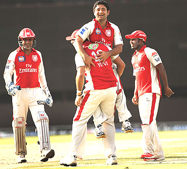 Piyush Chawla of the Kings celebrates with team-mates after picking Paul Collingwood