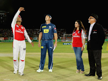 Kumar Sangakkara of the Kings XI tosses the coin with Adam Gilchrist of the Deccan Chargers