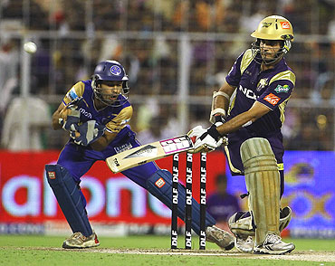 Sourav Ganguly (right) plays a shot on the leg side as Naman Ojha looks on