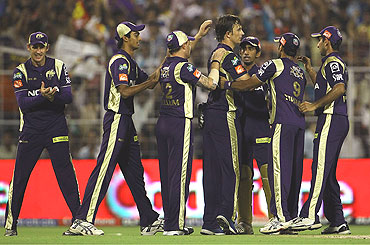 Shane Bond (centre) is congratulated by team-mates after claiming the wicket of Shikhar Dhawan