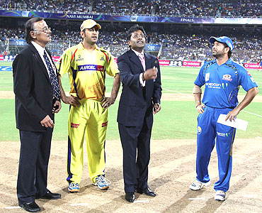 Match referee Venkat Raghavan (left), M S Dhoni (second from left), and Sachin Tendulkar (right) watch as IPL Commissioner Lalit Modi tosses the coin