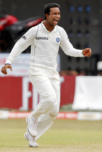 India's Pragyan Ojha celebrates taking the wicket of Sri Lanka's captain Kumar Sangakkara