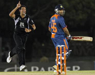 Daryl Tuffey celebrates taking the wicket of Rohit Sharma