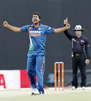 India's Praveen Kumar celebrates taking a wicket against Sri Lanka