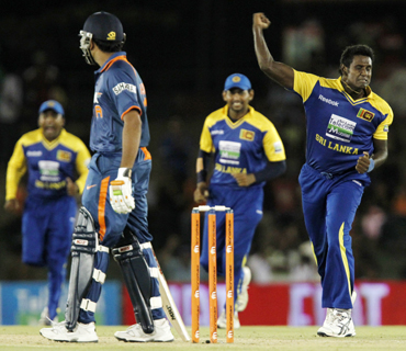 Sri Lanka's Angelo Mathews (right) celebrates taking the wicket of India's Rohit Sharma