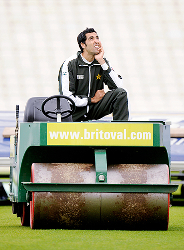 Umar Gul gazes into the sky while his teammates attend a training session
