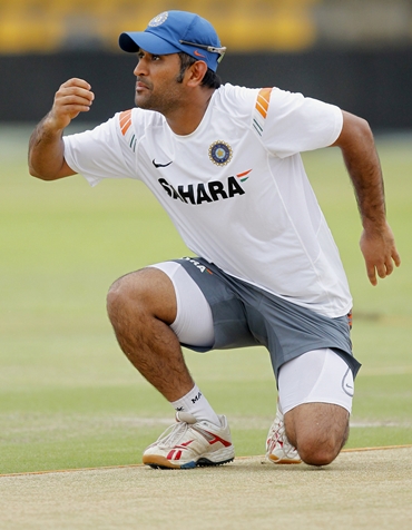 Mahendra Singh Dhoni examines the pitch for Wednesday's clash against New Zealand