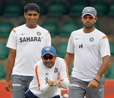 Virender Sehwag (centre), Munaf Patel (left) and Yuvraj Singh go through a catching practice session