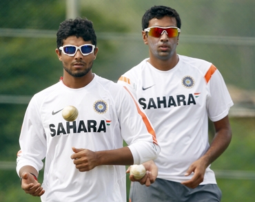 Ravindra Jadeja (left) and R Ashwin await their turn to bowl in the nets