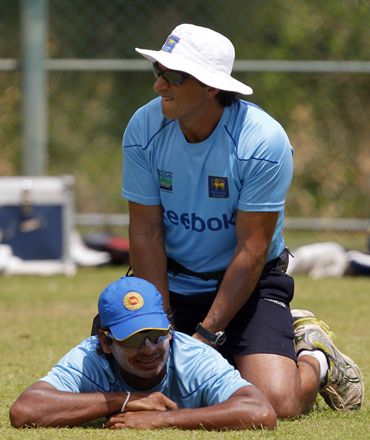 Sri Lanka's captain Sangakkara is treated by team physiotherapist Clark during a practice session