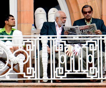 Pakistan Manager Yawar Saeed (right) and asst manager Shafqat Ranan read a newspaper as Kamran Akmal looks on.