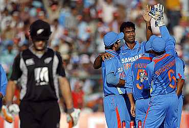 Munaf Patel celebrates with team-mates after picking up the wicket of Kane Williamson during the second ODI in Jaipur