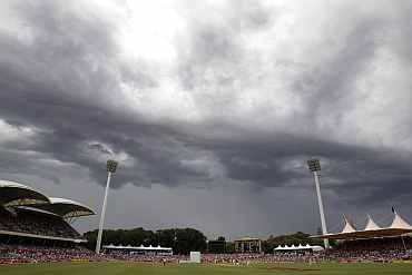 Storm clouds are seen during the third day of the second Ashes Test in Adelaide