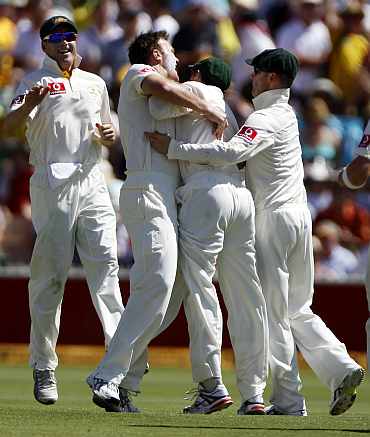 Australian team celebrate after picking up a wicket