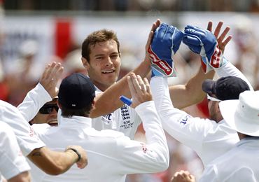 England pacer Tremlett is congratulated by teammates for taking the wicket of Hughes