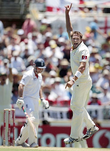 Australia's Ryan Harris appeals successfully for the wicket of England's Andrew Strauss (left)