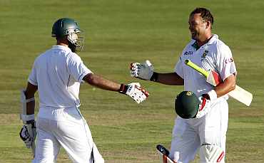 South Africa's Jacques Kallis celebrates with Hashim Alma after completing his century