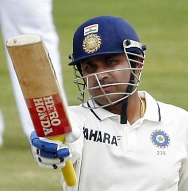 Virender Sehwag celebrates after scoring his half-century