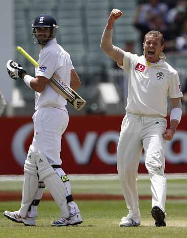 Australia's Peter Siddle celebrates after picking up England's Kevin Pietersen during the fourth Ashes Test against Australia in Melbourne