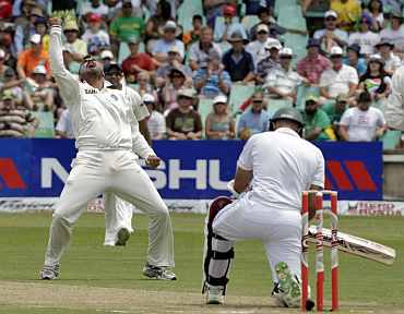 India's Harbhajan Singh celebrates after picking up South Africa's Hasim Amla during the second Test in Durban