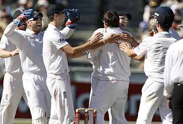 England's Graeme Swann celebrates after picking up an Australian wicket during the fourth Ashes Test in Melbourne