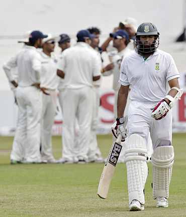 South Africa's Hasim Amla walks back to the pavillion after being dismissed by India's S Sreesanth during the second Test in Durban