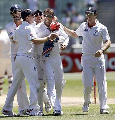 England players celebrate after winning the Ashes Test match in Melbourne