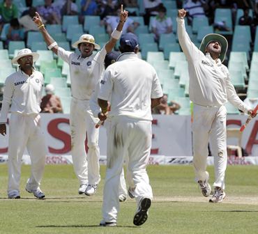India's players celebrate the fall of a South Africa wicket in Durban