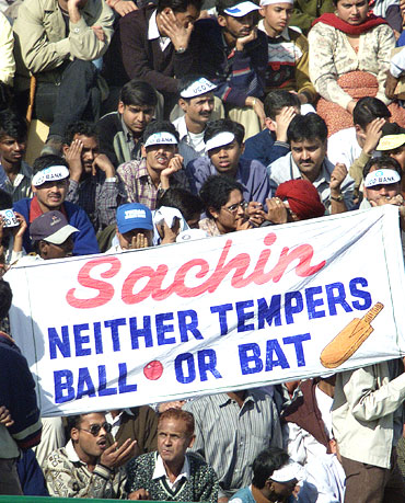 Fans hold a banner during a match in support of Sachin Tendulkar
