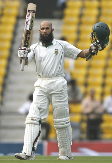 Hashim Amla raises the bat after completing his century