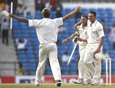 South Africa's captain Graeme Smith celebrates with Dale Steyn and Paul Harris after winning the first Test