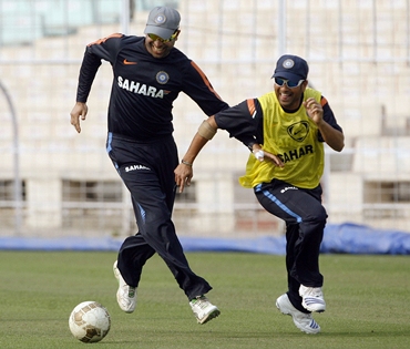 Sachin Tendulkar and VVS Laxman chase a football during practice