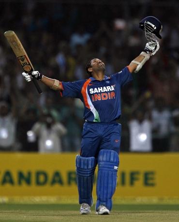 Sachin Tendulkar raises his bat to the stars on completing his double century