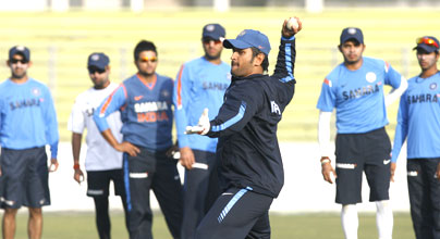 Indian skipper Mahendra Singh Dhoni is involved in fielding drills at a training session in Dhaka