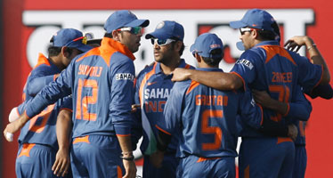 Indian players celebrate after picking a wicket