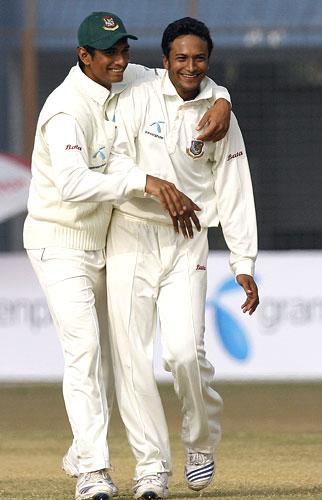 Bangladesh's Mahmudullah (left) congratulates captain Shakib Al Hasan after picking a wicket
