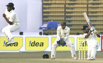 India's Amit Mishra (right) plays a shot as Bangladesh's Shahriar Nafees (left) takes evasive action