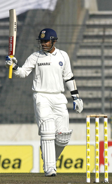 Virender Sehwag acknowledges the crowd after completing a half century
