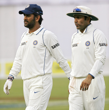 India's captain MS Dhoni and Virender Sehwag come off the field after the third day's play
