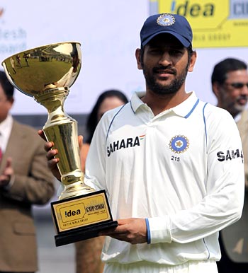 India captain Mahendra Singh Dhoni holds the winners trophy