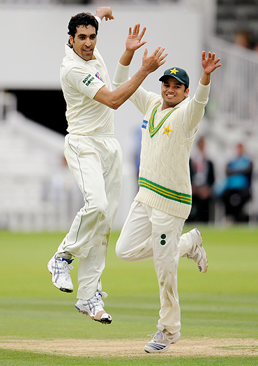 Umar Gul (left) celebrates with Azhar Ali after dismissing Austalia's Tim Paine