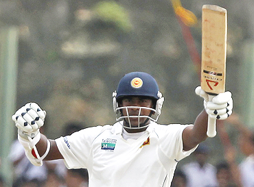 Rangana Herath celebrates after reaching his half-century