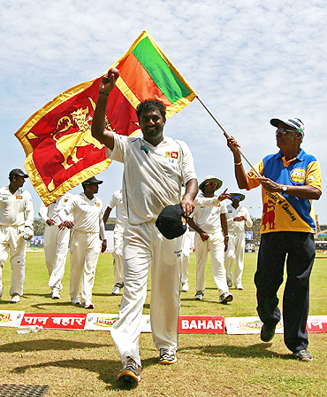 Mutthiah Muralitharan walks off after picking five wickets at the end of India's first innings