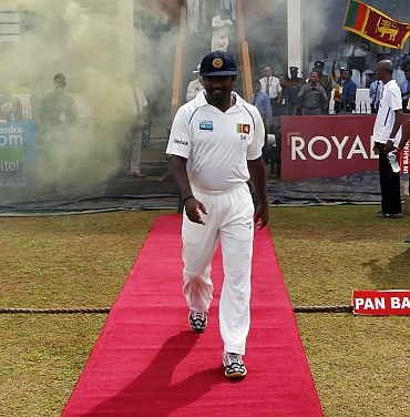 Muttiah Muralitharan walks on to the field during the fifth day of the first Test