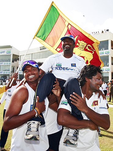 Muttiah Muralitharan is lifted by his teammates after Sri Lanka's victory over India in the first Test on Thursday