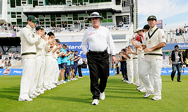 The Australian squad form a guard of honour for umpire Rudi Koertzen (centre) before the fourth day of the second cricket Test at Headingley Carnegie cricket ground in Leeds on Saturday