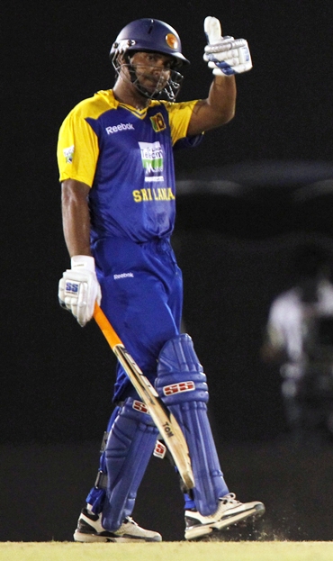 Sri Lanka's captain Kumar Sangakkara waves to the crowd after completing fifty